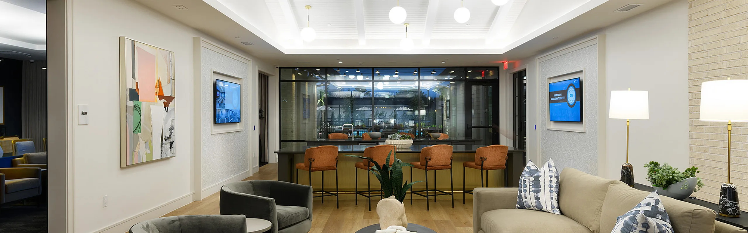Modern and inviting living area featuring elegant lighting, plush seating, contemporary artwork, and a stylish open lounge perfect for relaxation and entertaining.