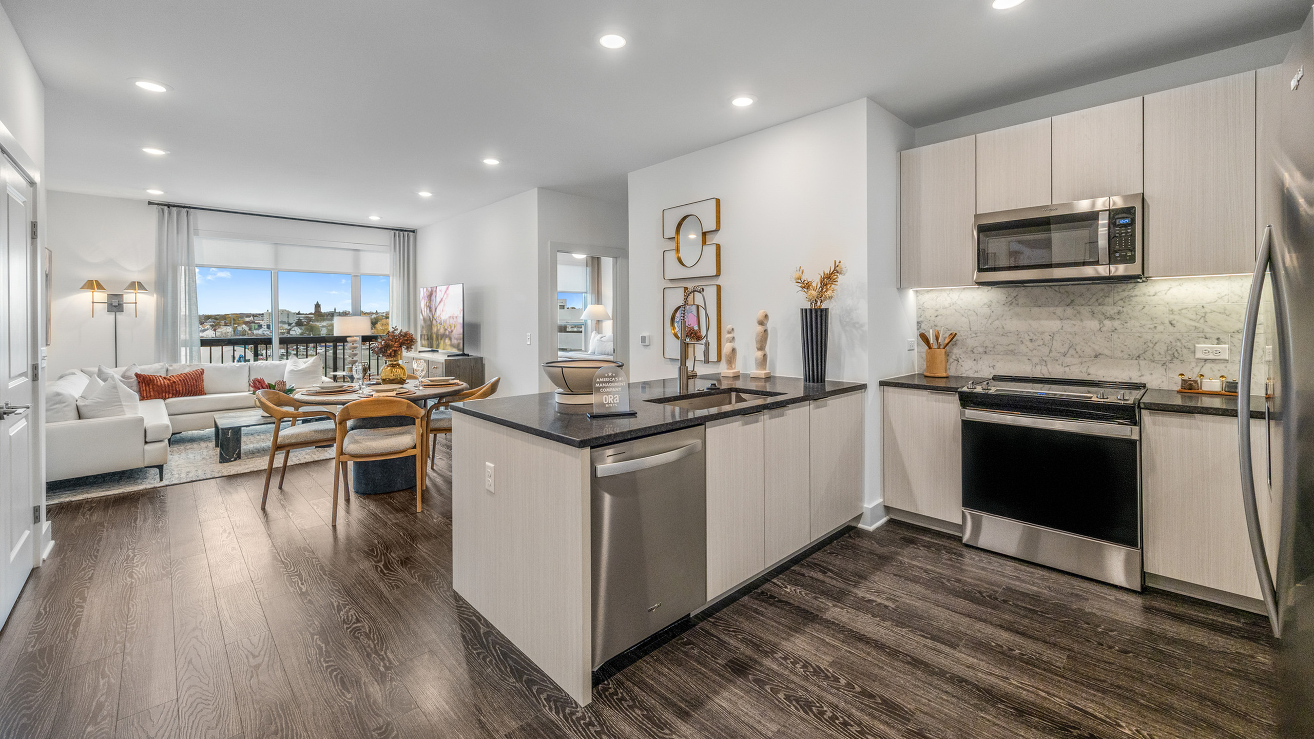 Modern open-concept apartment with a chic kitchen, stylish living area, and large windows offering stunning views.