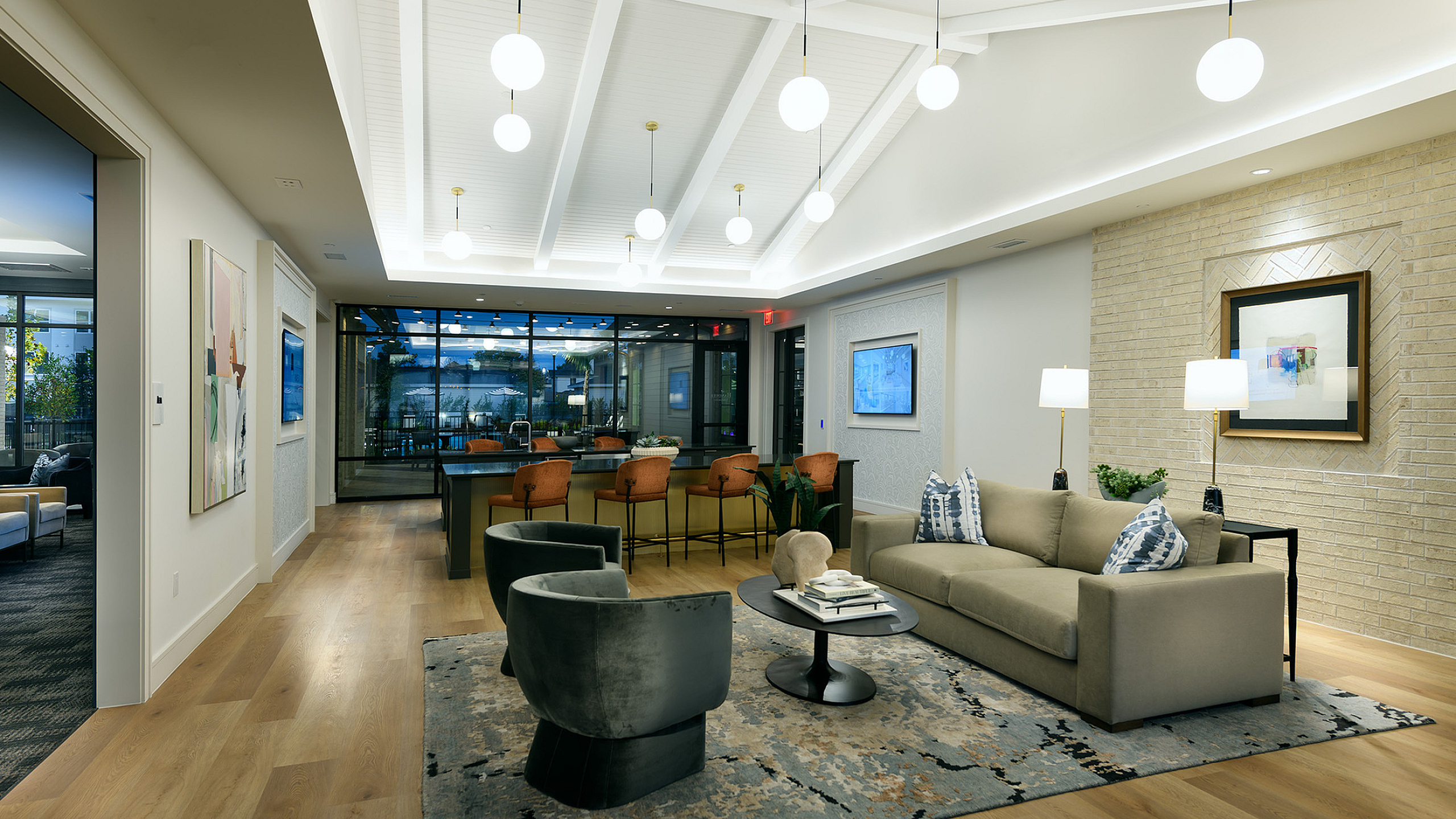 Luxurious open-concept living area with modern decor, plush seating, and elegant lighting, perfect for entertaining.