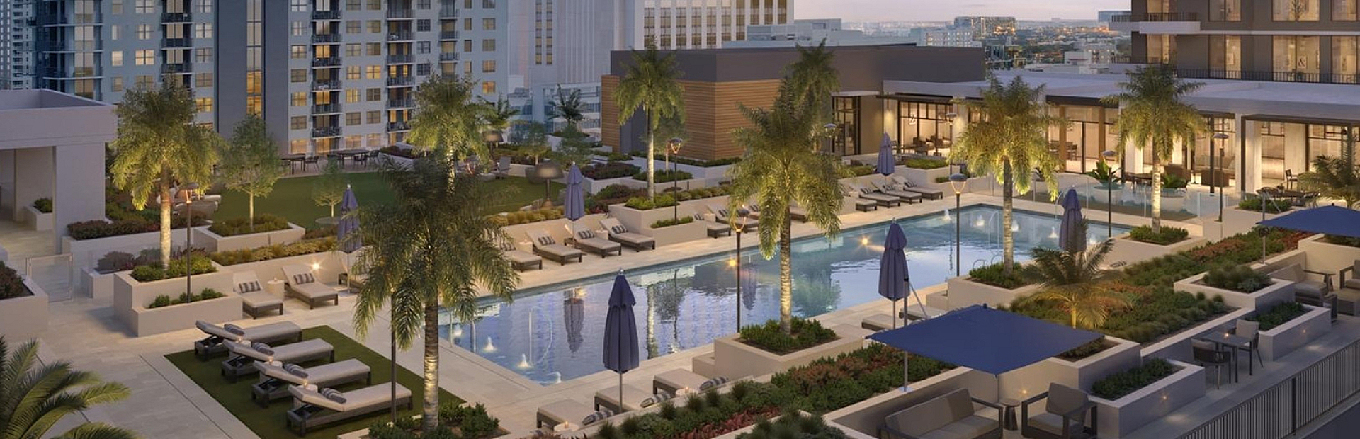 Luxurious apartment complex with a stunning rooftop pool, modern lounge areas, and lush greenery at sunset.