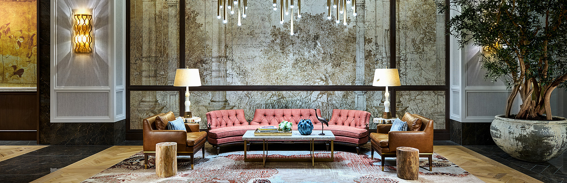 Elegant lobby with stylish decor featuring a plush seating area, contemporary lighting, and exquisite wall art, creating a luxurious atmosphere.