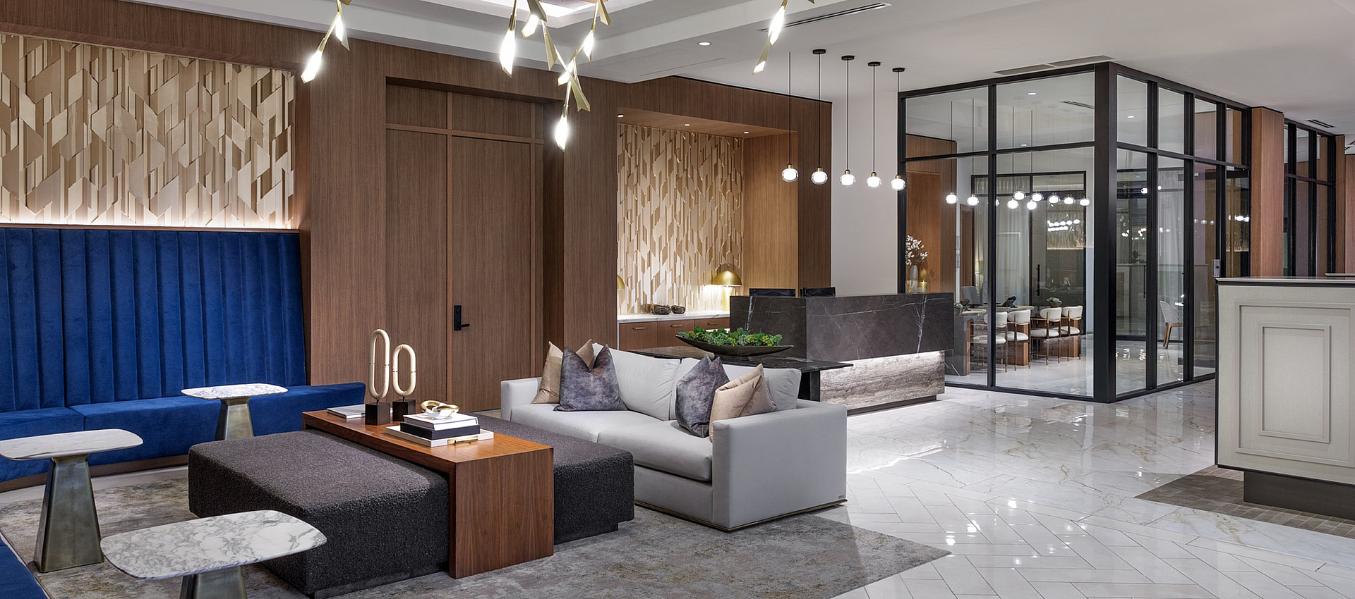 Elegant open-concept living area with modern lighting, plush seating, and luxurious marble flooring, perfect for stylish entertaining.