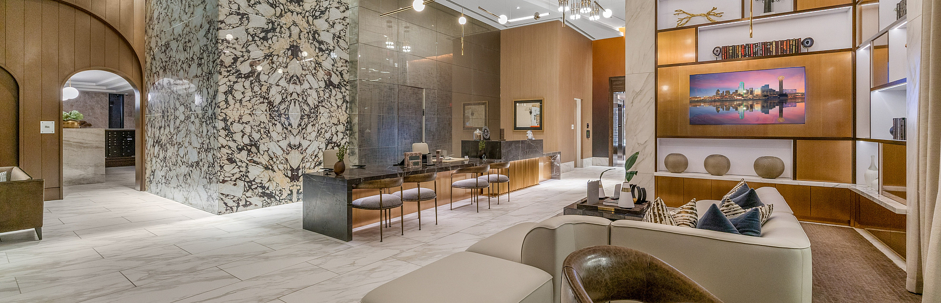 Luxurious apartment lobby featuring elegant marble accents, modern lighting, and stylish seating areas for a sophisticated welcome.