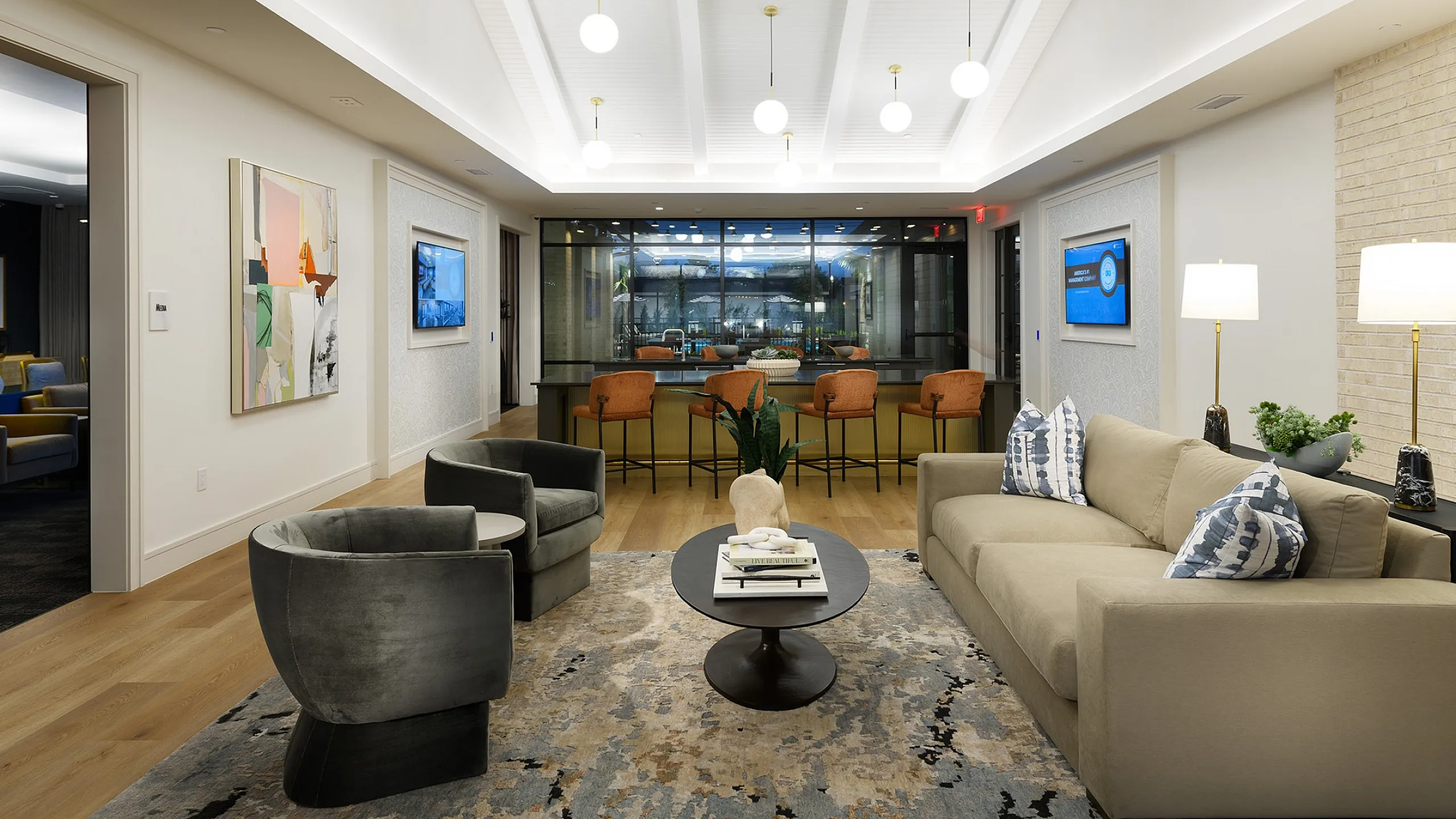 Luxurious modern living area featuring a cozy beige sofa, stylish armchairs, and chic decor with vibrant wall art and ambient lighting.