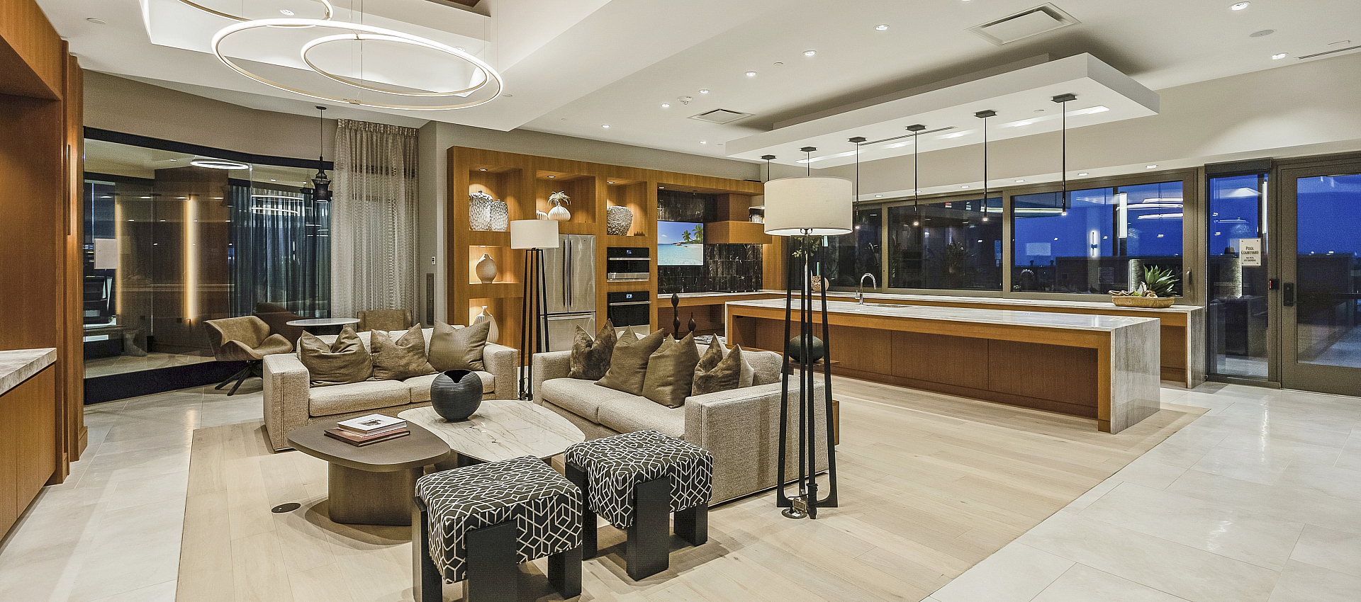Luxurious open-concept living space with modern decor, elegant lighting, and a spacious kitchen, perfect for entertaining.
