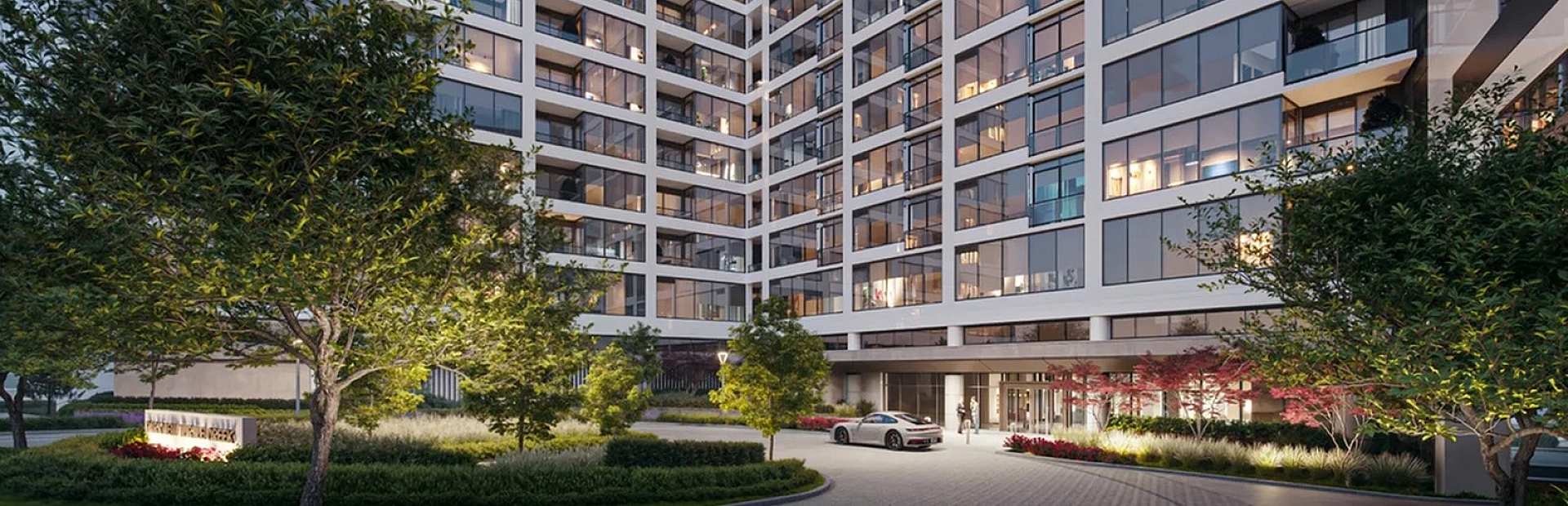 Contemporary high-rise apartment building with lush landscaping and modern entrance, offering luxury urban living.