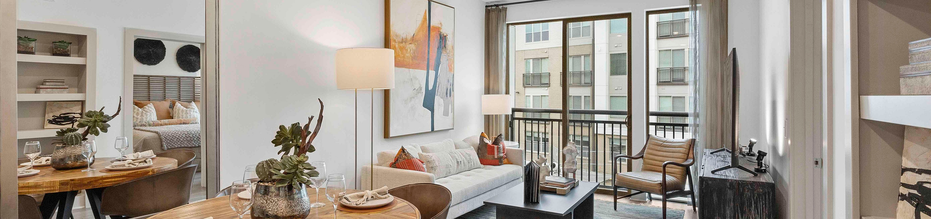 Modern apartment interior featuring an elegant dining area, cozy living space with natural light, and contemporary decor.
