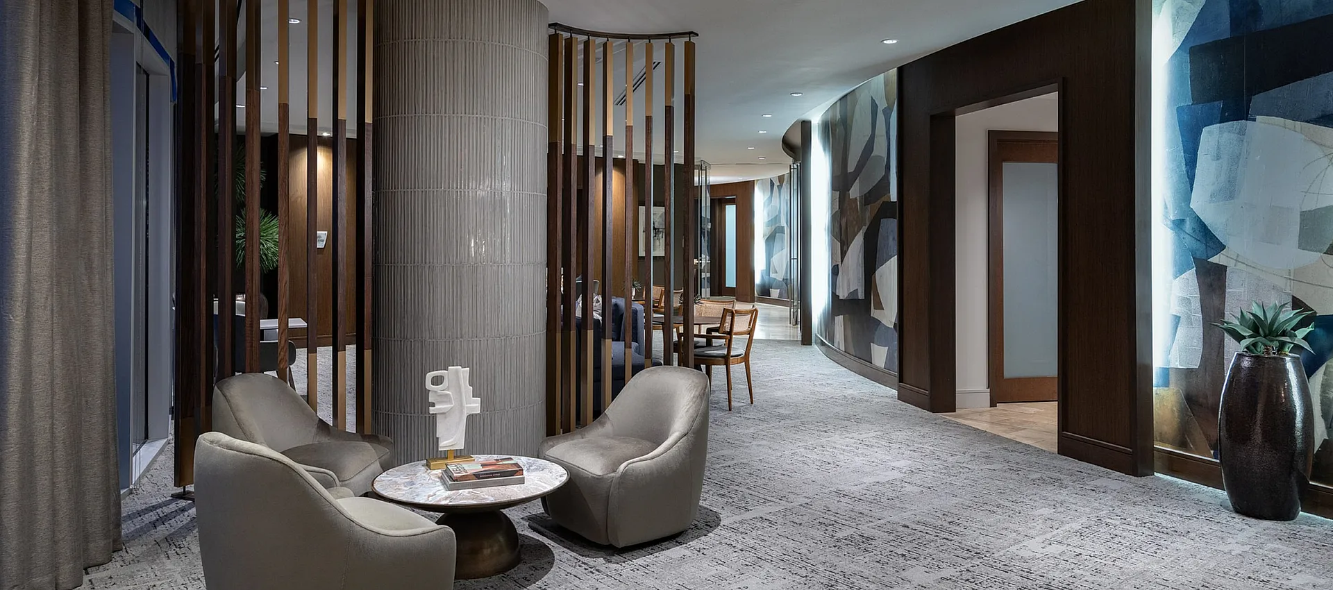 Chic modern hallway with elegant seating area, unique art installations, and soft ambient lighting.