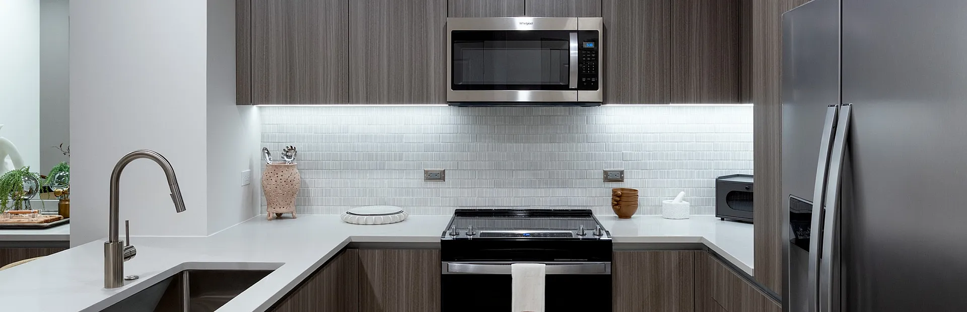 Modern kitchen with sleek stainless steel appliances, elegant cabinetry, and a bright, minimalist design.