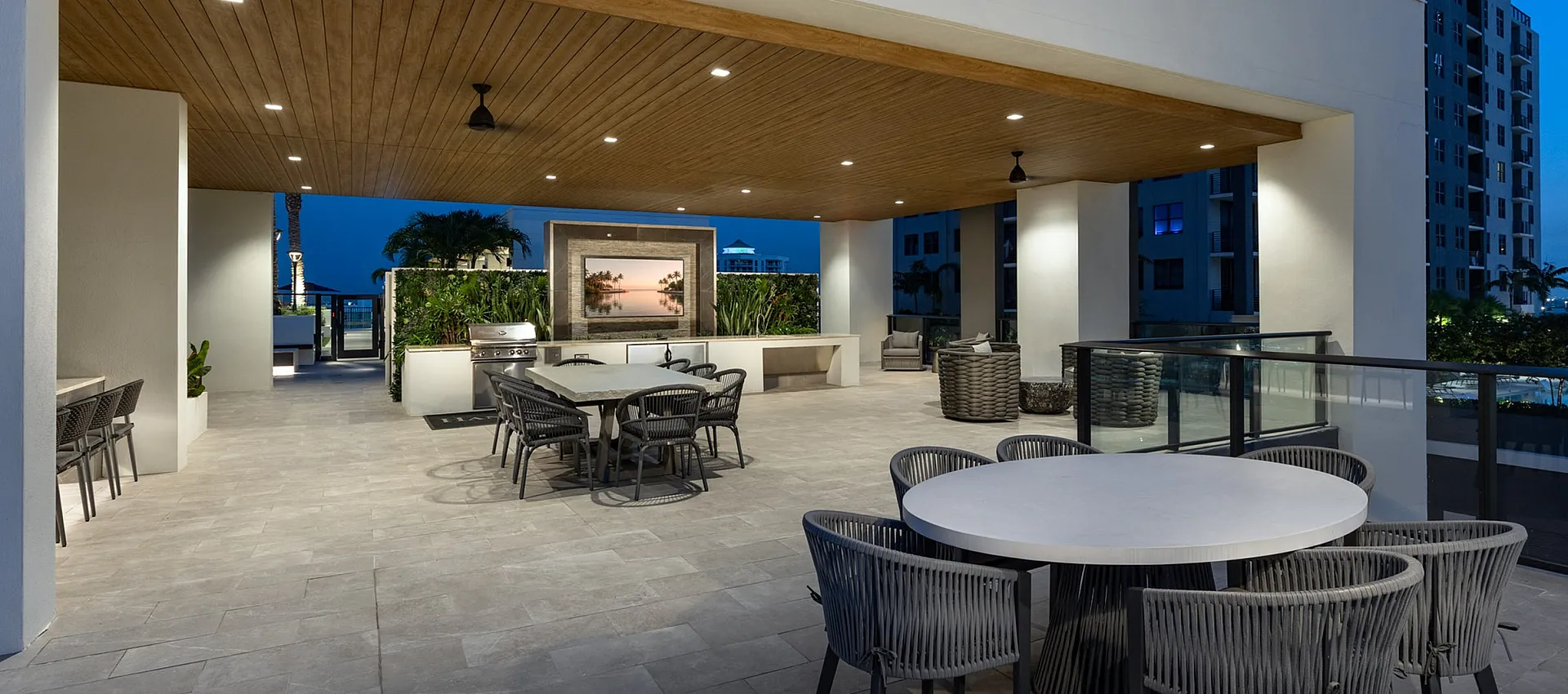 Elegant outdoor terrace at dusk featuring modern seating, ambient lighting, and a scenic view of the city skyline.
