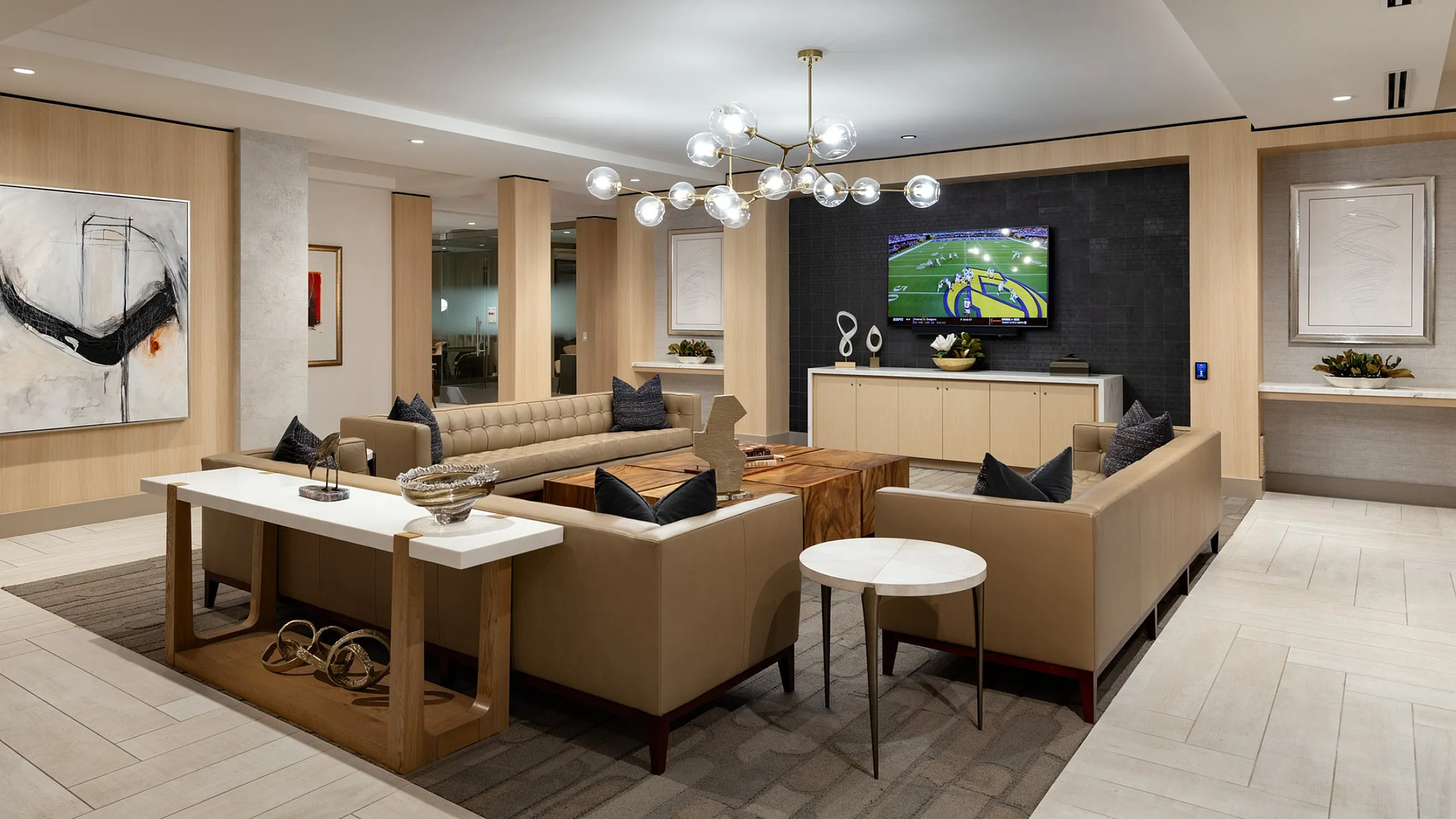 Elegant modern living room with stylish decor, featuring a plush sofa, sleek coffee table, and contemporary lighting fixture, perfect for entertaining.
