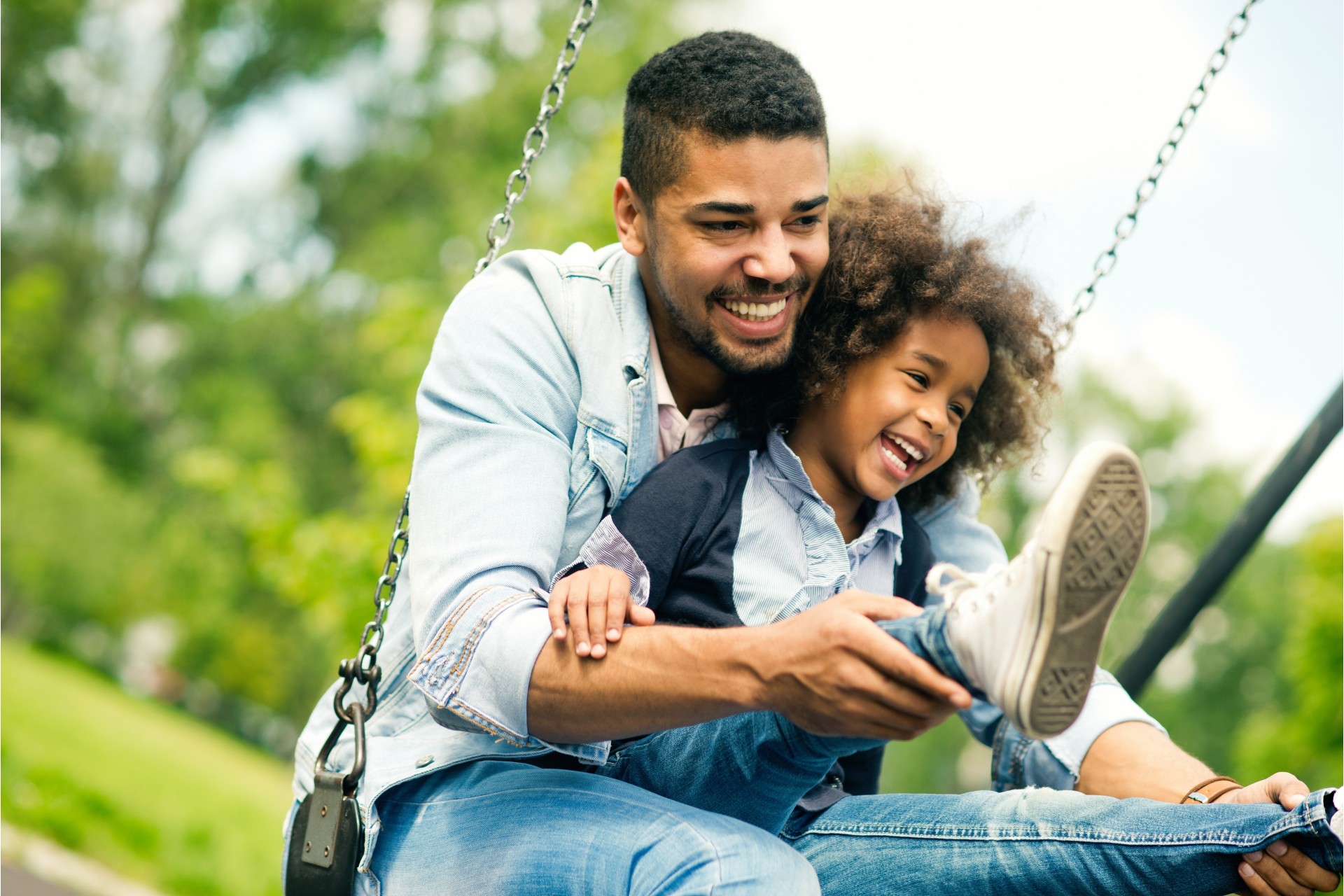 dad and son playing on swing