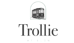 Elegant logo featuring a vintage trolley design above the bold word 'Trollie' with a refined and modern aesthetic.
