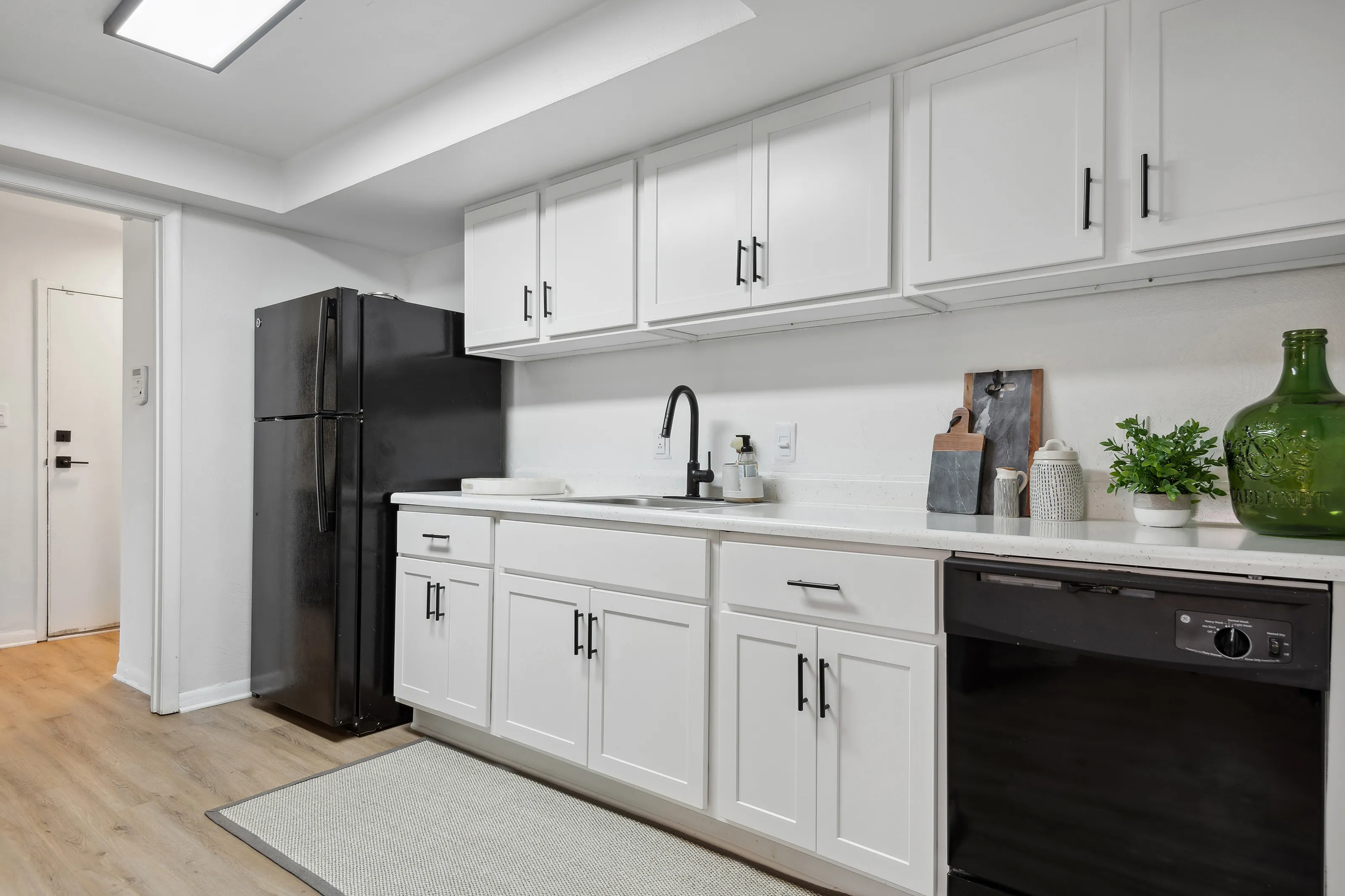 Large kitchen at ReNew Virginia Beach with updated cabinetry, new matte black fixtures, and black appliances