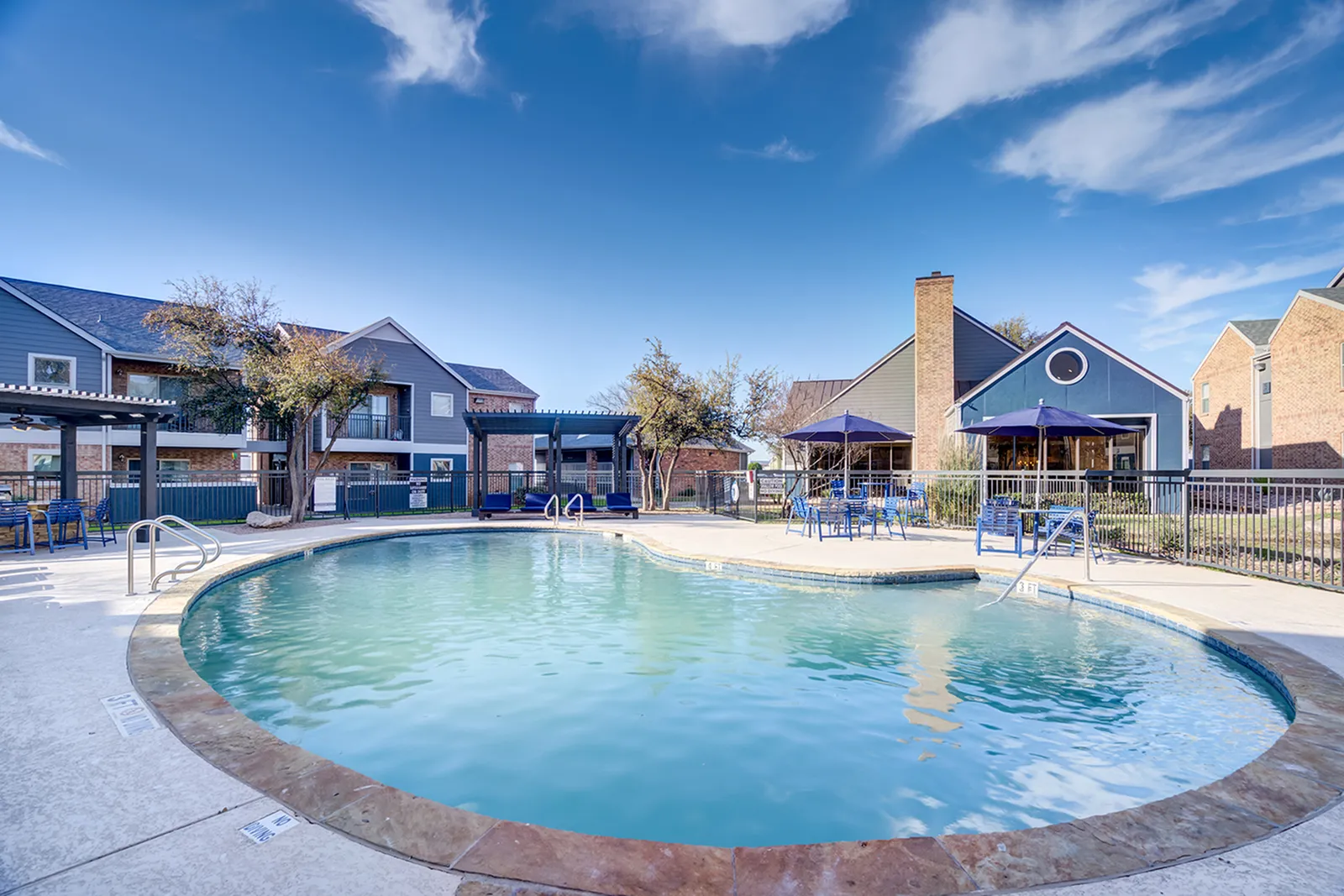 Sparkling swimming pool and sundeck at ReNew Midland on a sunny day