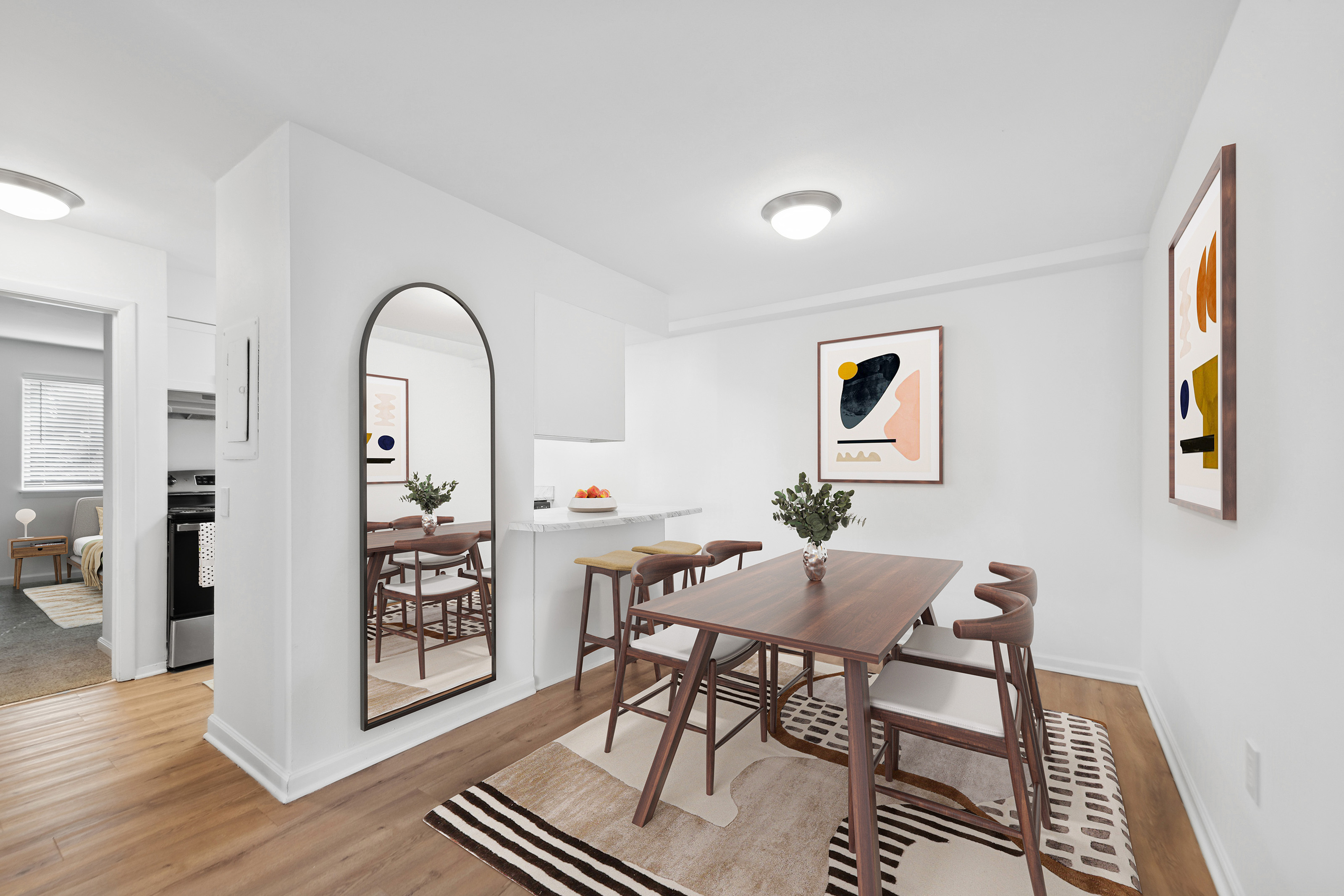 Sleek dining area with stylish wood furniture and modern artwork on the walls.
