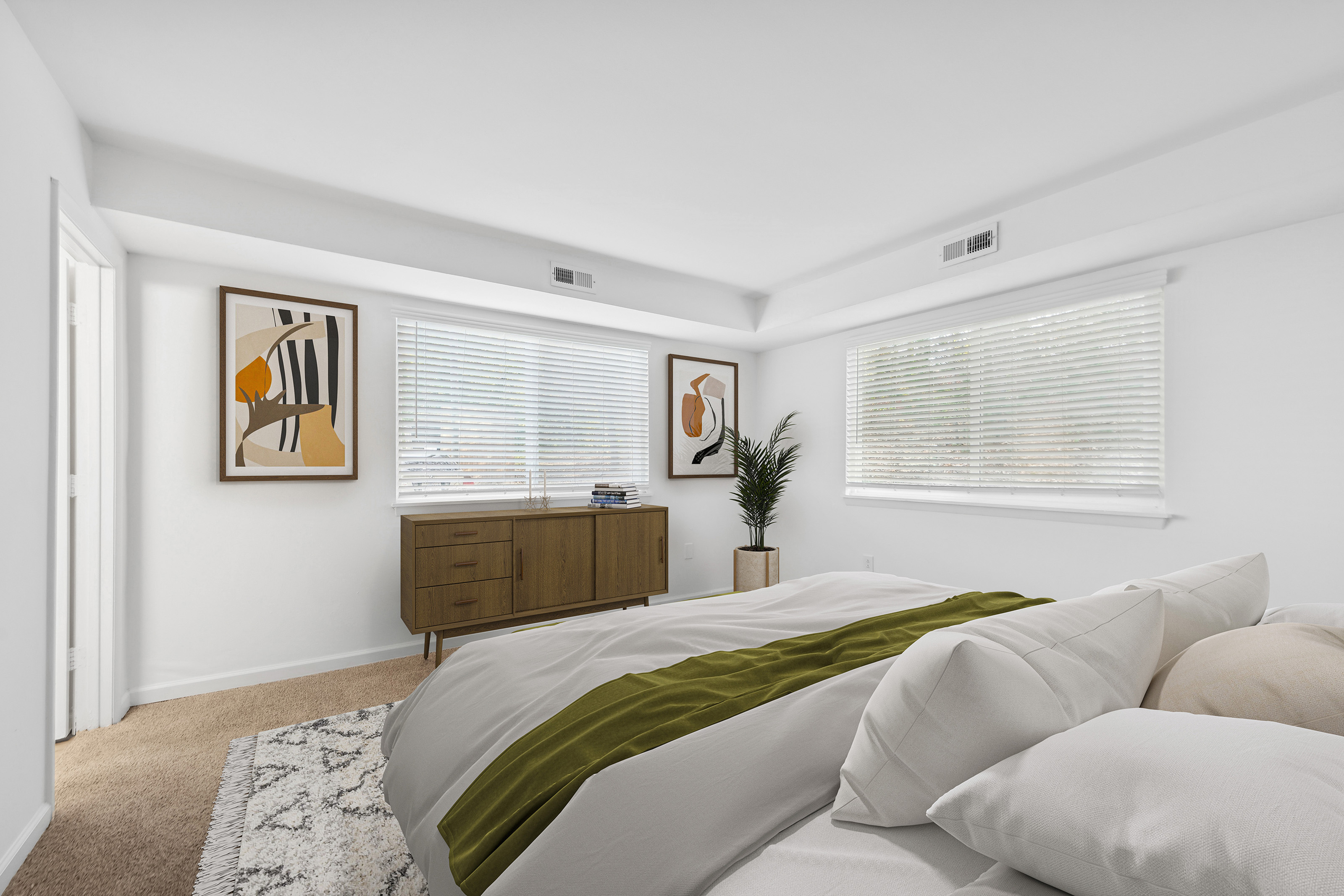 Bright and modern bedroom with minimalist furnishings and stylish artwork.