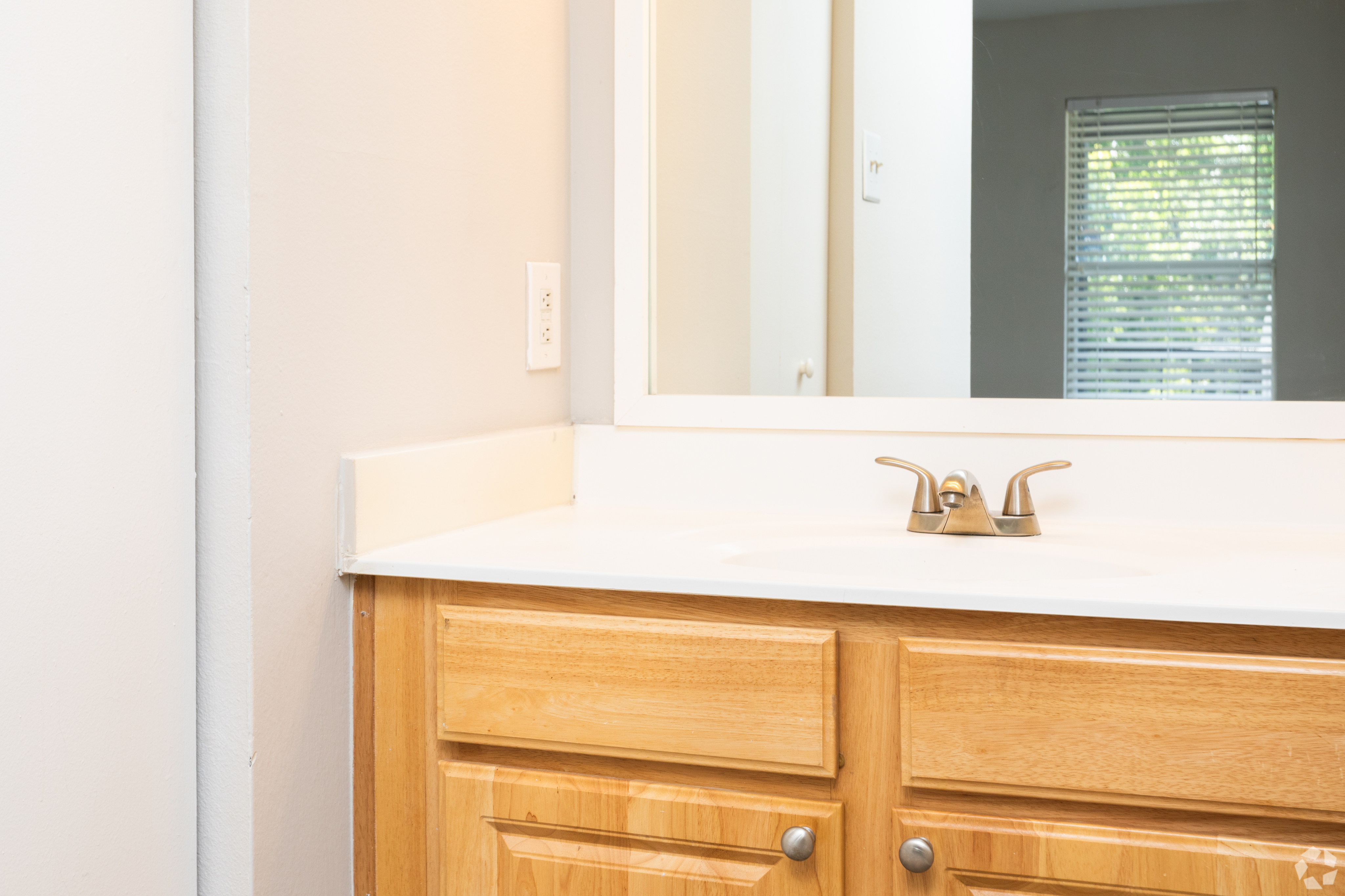 Elegant bathroom vanity with a wooden cabinet and polished faucet.