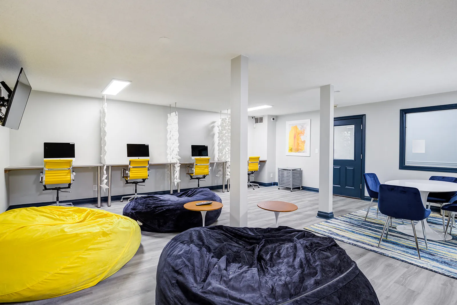 Business center with Apple computers and a table with chairs