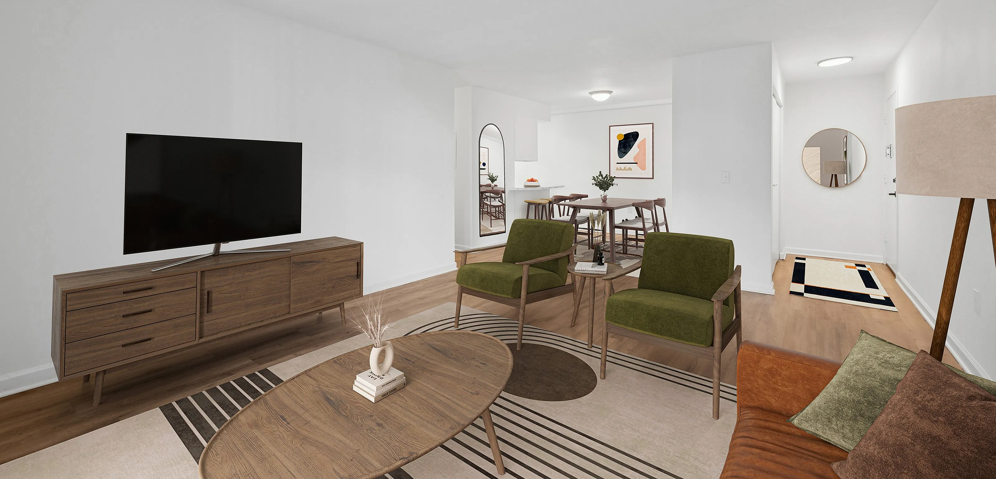 Inviting open-concept living room with modern decor, featuring a cozy seating area, stylish wooden furniture, and a wall-mounted TV.