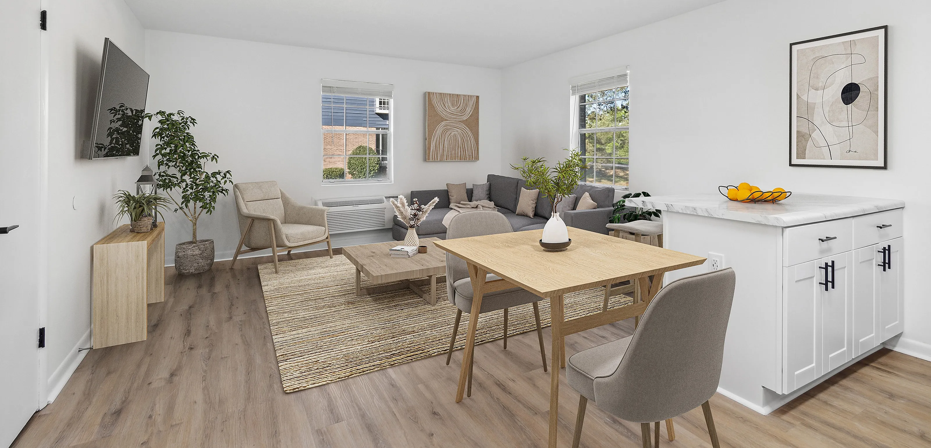 Bright and modern living room with elegant furniture, wooden flooring, and large windows.
