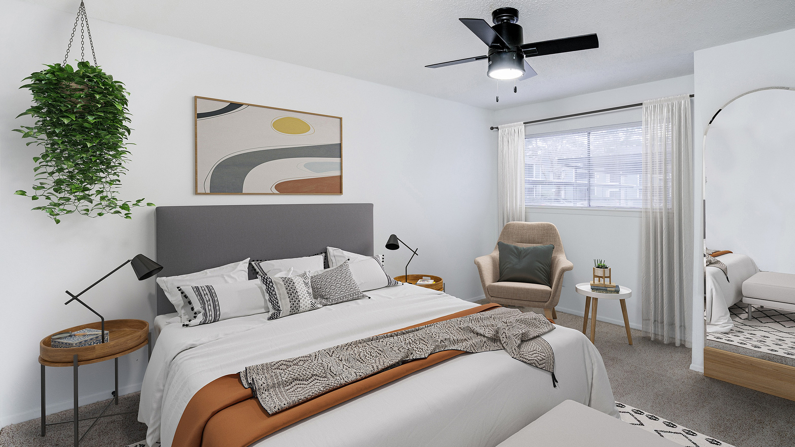Modern bedroom with a cozy king-sized bed, elegant decor, and a stylish ceiling fan, offering a perfect blend of comfort and design.