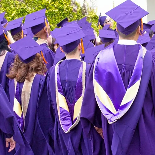 Vibrant graduation ceremony with students in purple gowns and caps, celebrating academic success.