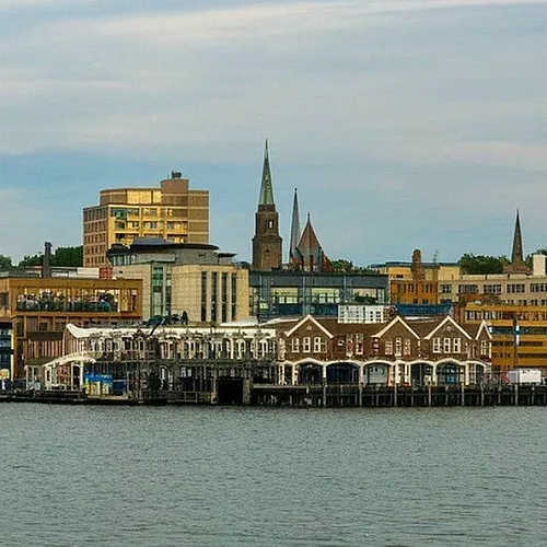 Charming waterfront cityscape with diverse architecture, featuring a vibrant downtown area and scenic harbor views.