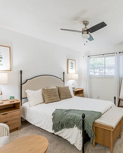 Inviting bedroom with a cozy ambiance, featuring modern decor, soft lighting, and a comfortable bed nestled between stylish nightstands.