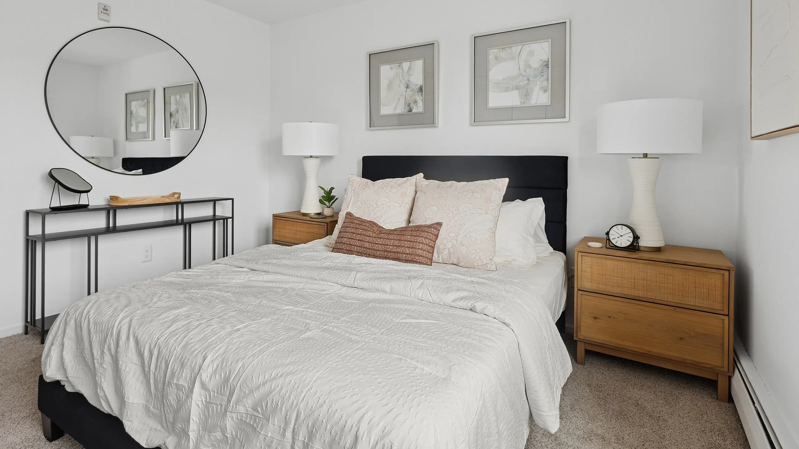 Charming bedroom with elegant decor, featuring a cozy bed, stylish nightstands, and vibrant wall art for a serene atmosphere.
