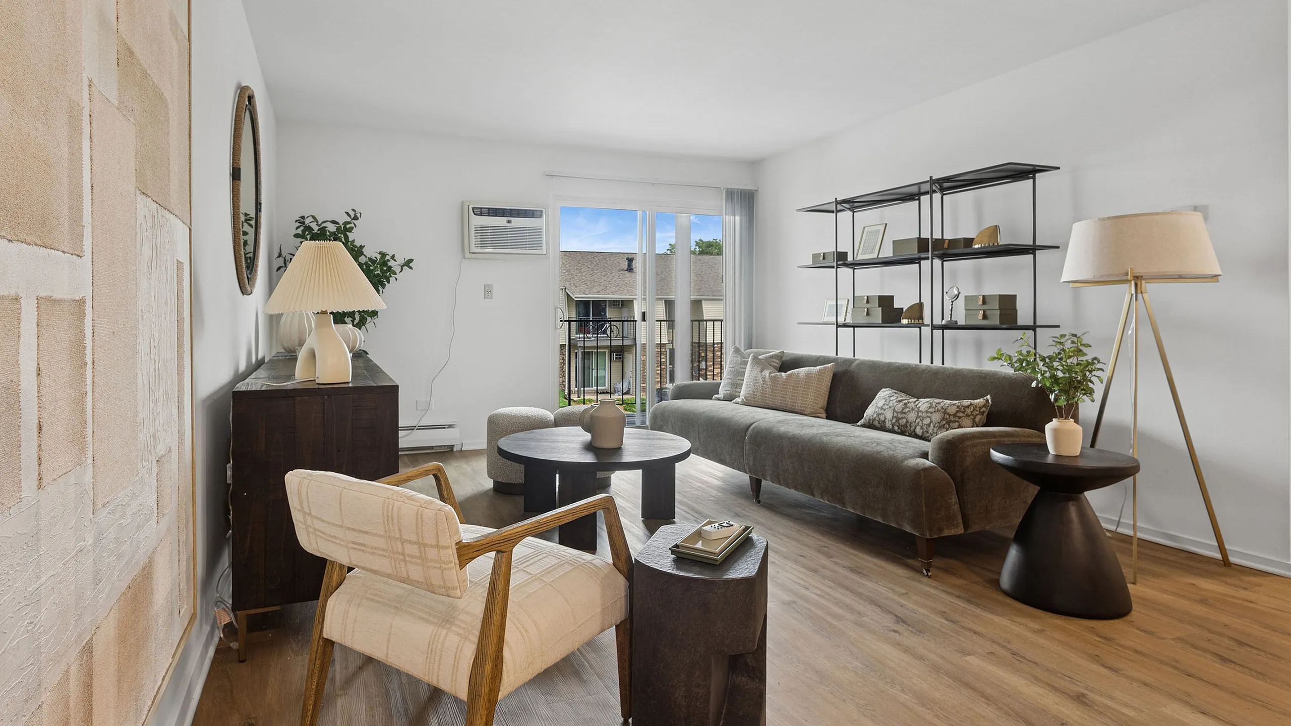 Bright and inviting living room with modern decor, featuring a comfortable sofa, elegant flooring, and a beautiful outdoor view.