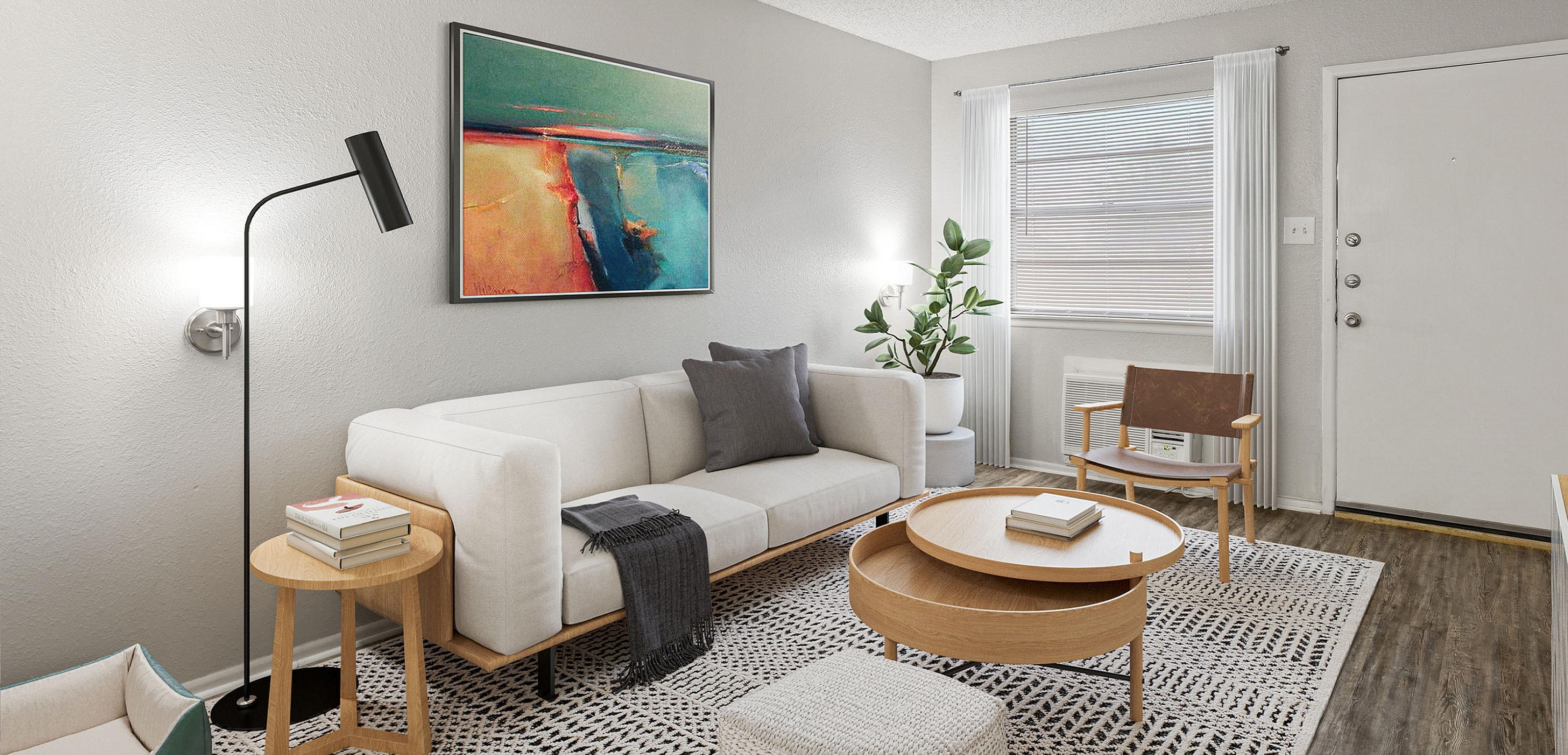 Modern living room with stylish decor, featuring a cozy white sofa, elegant wooden coffee table, chic floor lamp, and vibrant artwork on the wall.