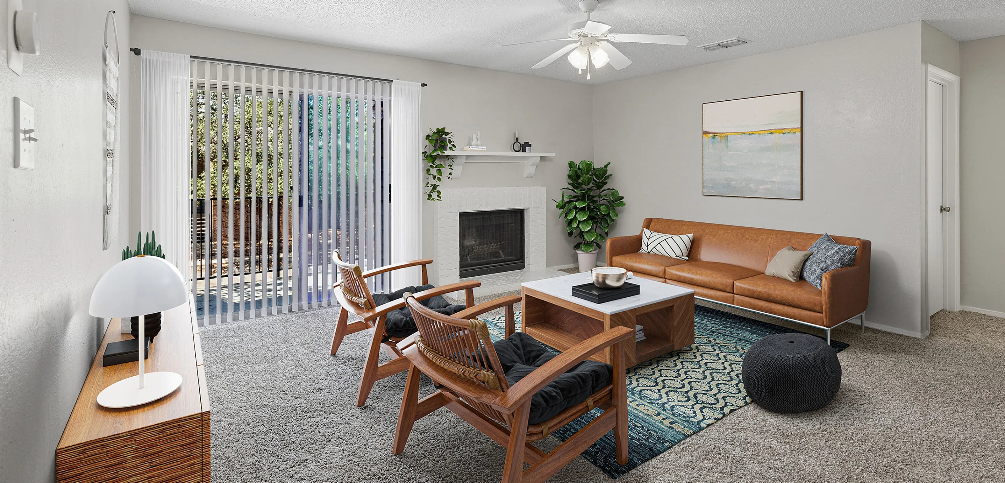 Inviting living room with a cozy fireplace, stylish leather sofa, and modern wooden chairs, bathed in natural light from large sliding glass doors.