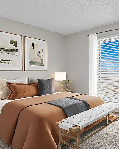 Bright and inviting bedroom with stylish decor, showcasing modern furniture, soft lighting, plush bedding, and a scenic window view.