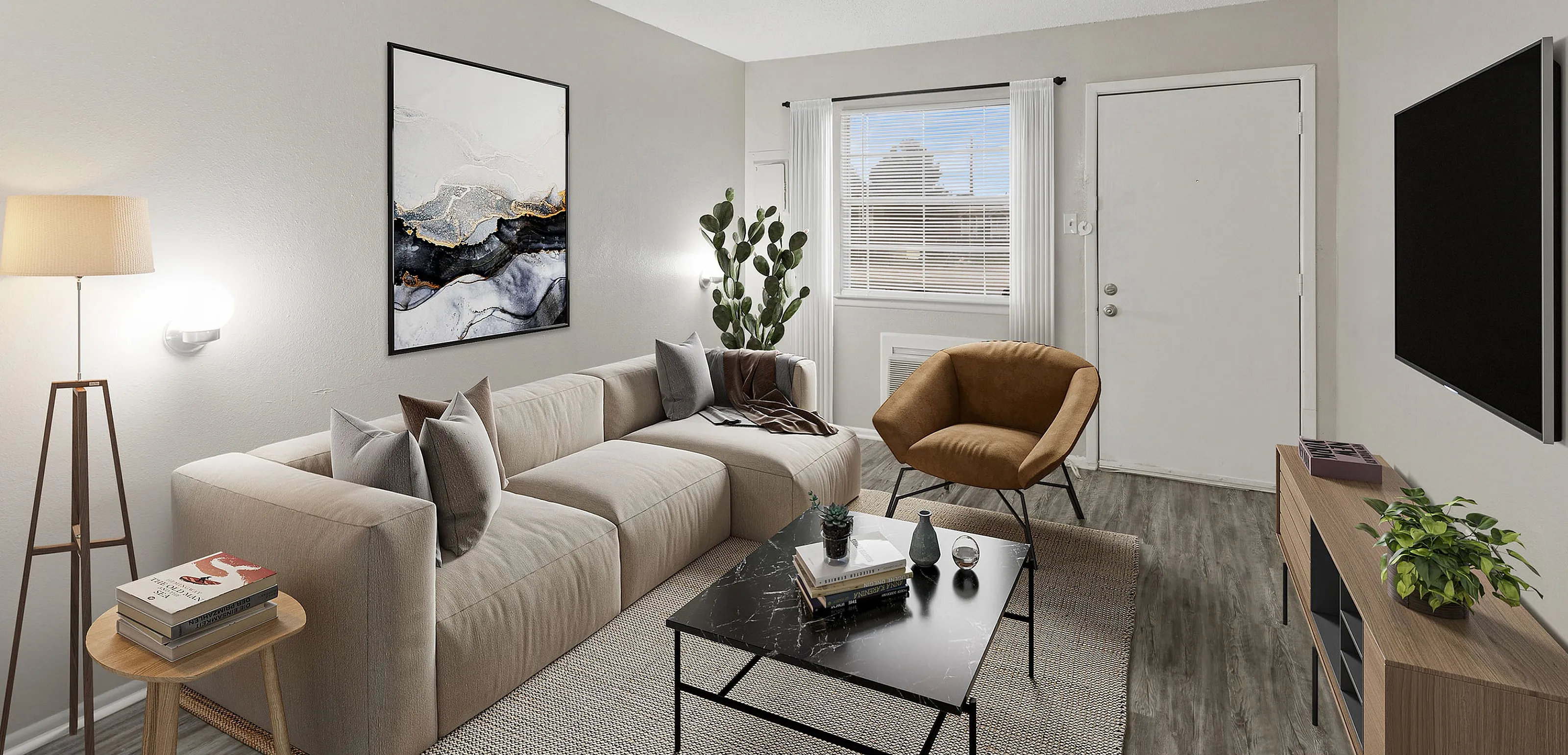 Chic and inviting living room featuring a modern beige sofa, stylish decor, and natural light streaming through a large window.