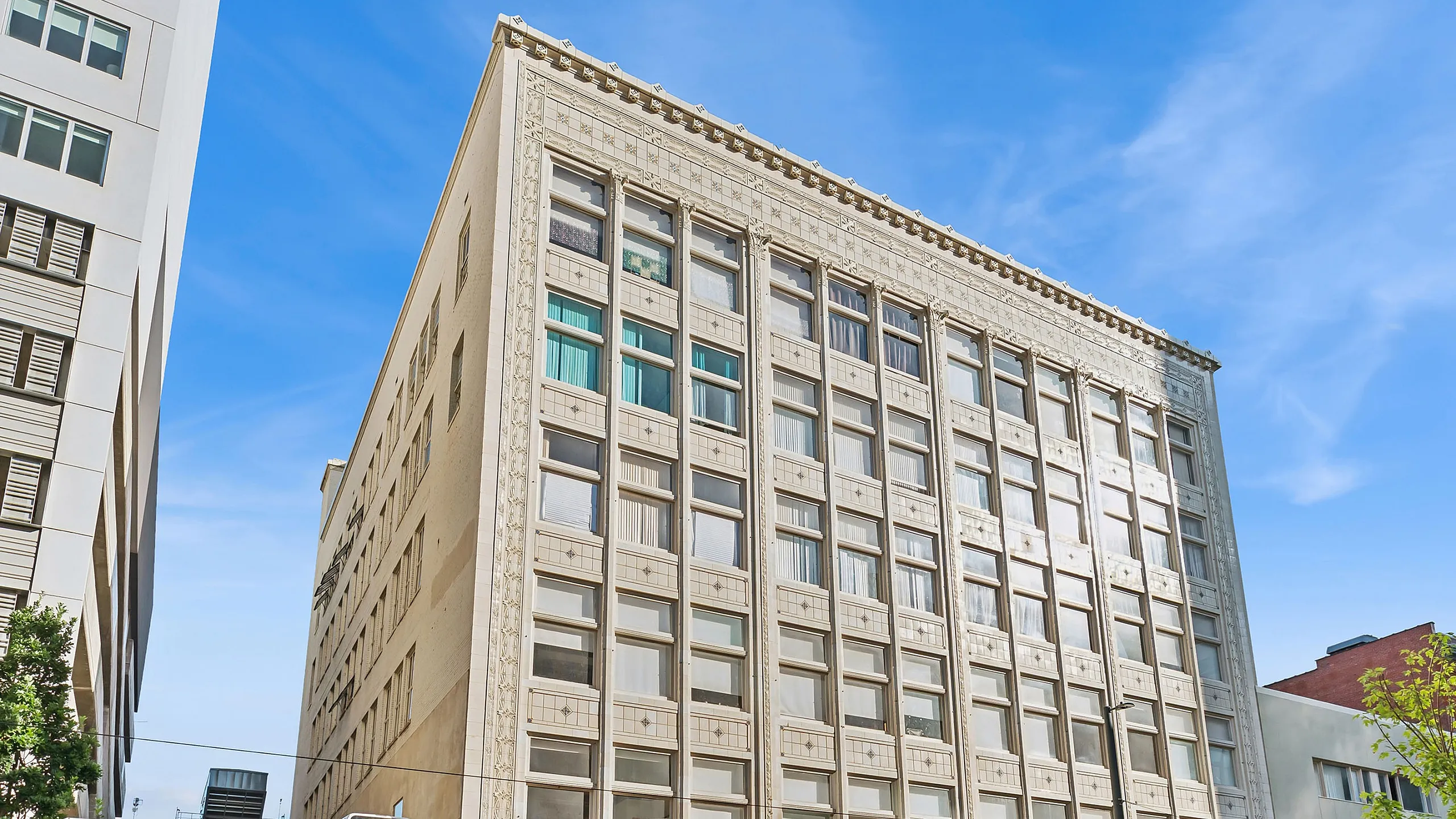 Charming urban building with classic architecture, featuring Renew Apartments and Mint Indian Restaurant on a sunny day.