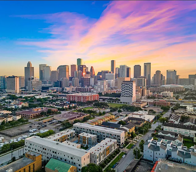 Vibrant cityscape showcasing a dynamic skyline at dusk, with colorful sky enhancing the urban view.