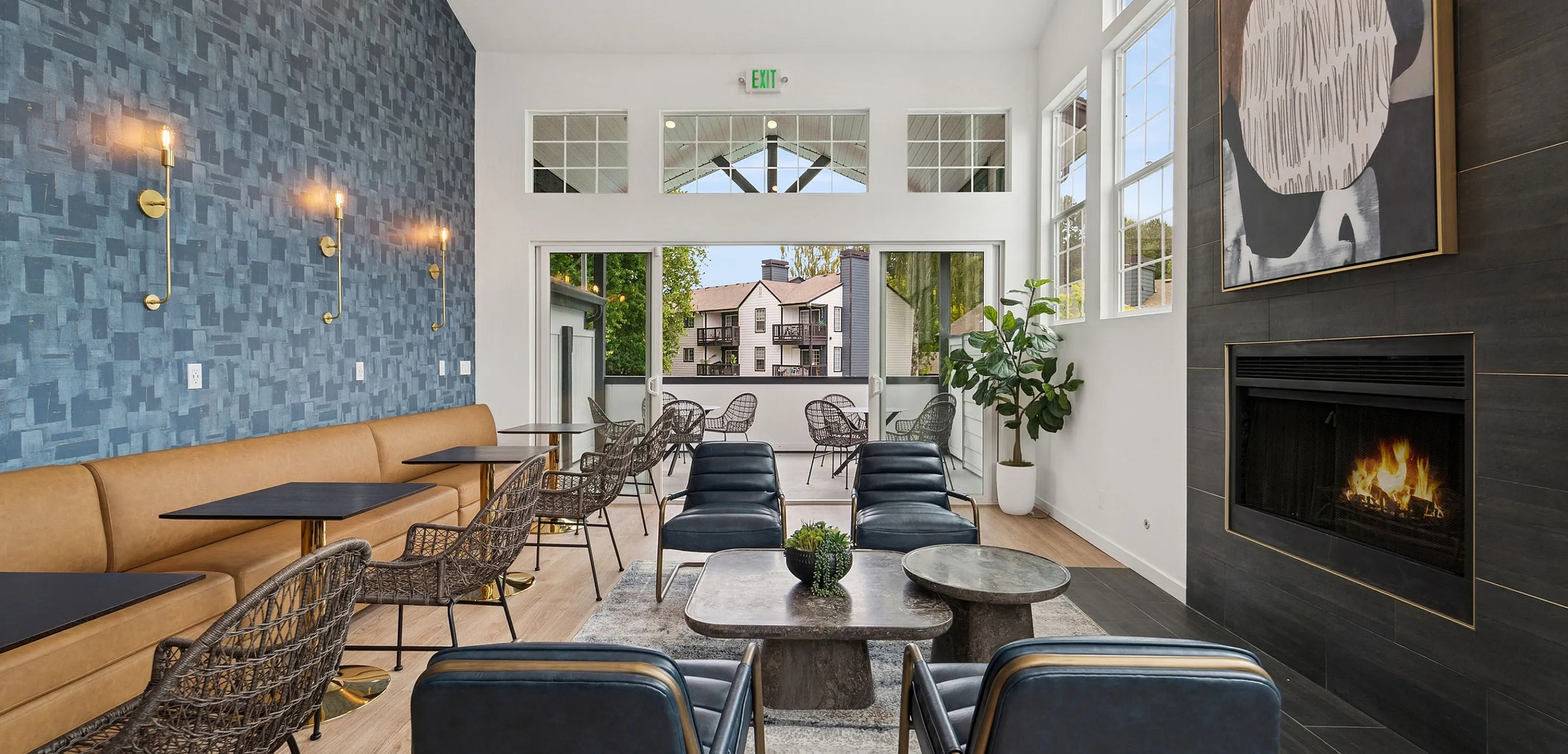 Elegant community lounge with modern seating, a stylish fireplace, and abundant natural light, offering a luxurious and inviting atmosphere.