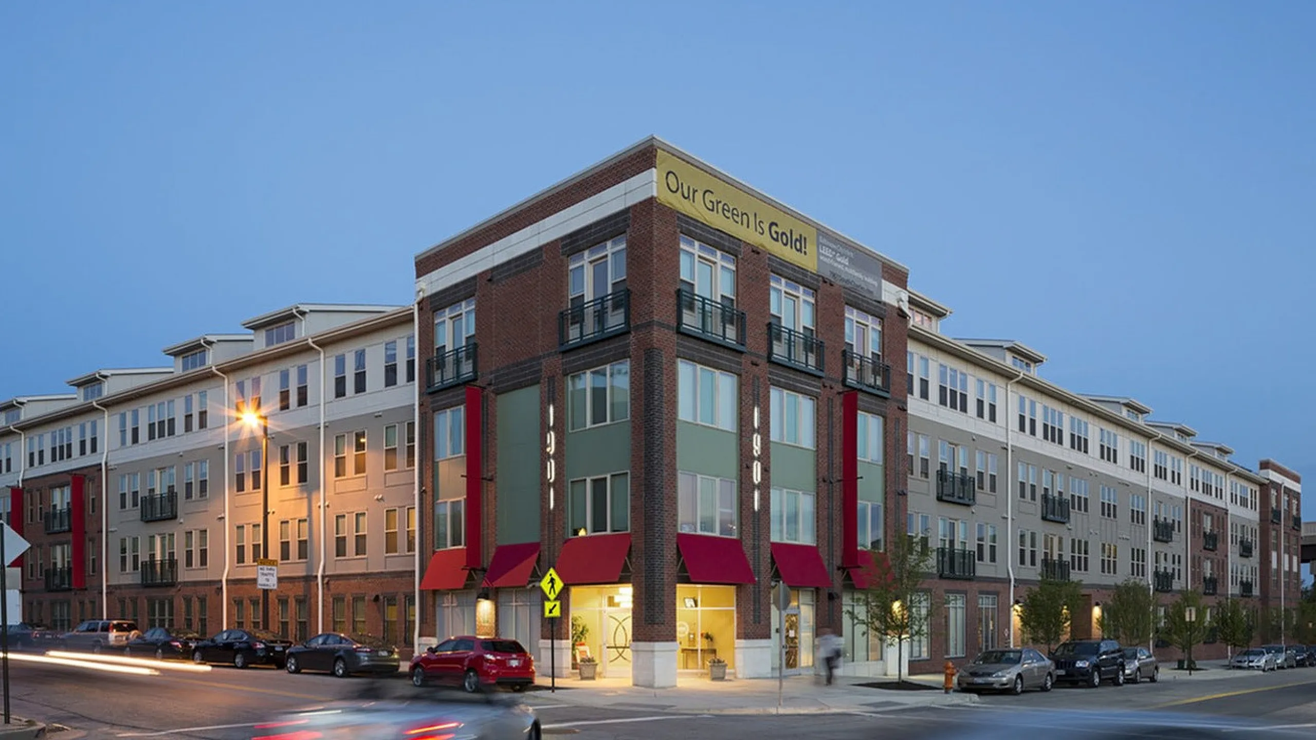Modern urban apartment complex with stylish facade and vibrant red accents, offering convenient city living.