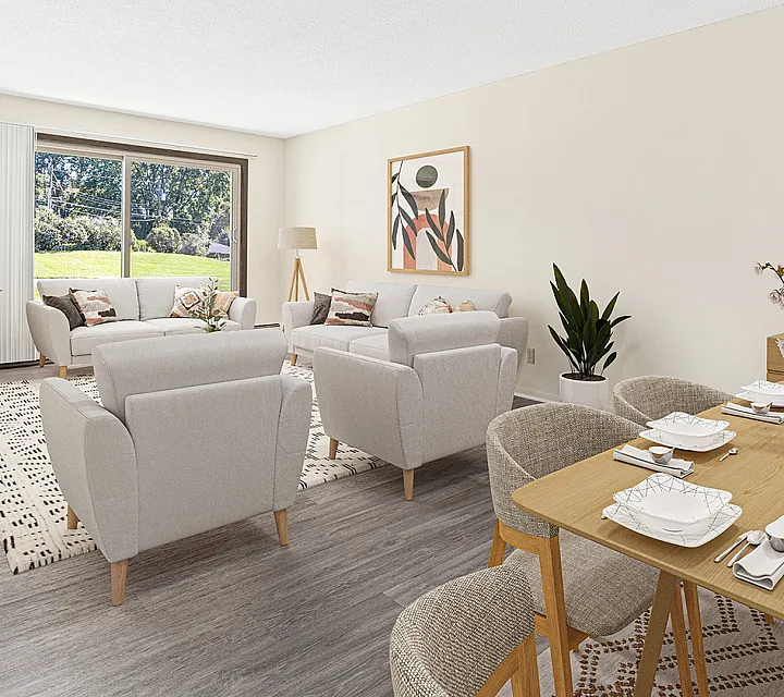 ReNew at the Grove bright and spacious living room with chic furniture, modern decor, and a large window overlooking green landscape, complemented by an elegant dining area.