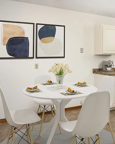 ReNew Meadow Lake bright and open dining room with modern dining room table and four place settings, fresh tulip flowers, and abstract art