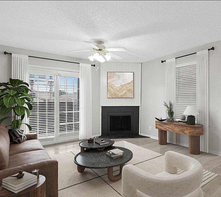 Chic ReNew Holiday Hill living room boasting modern decor, a cozy fireplace, and abundant natural light from large windows.