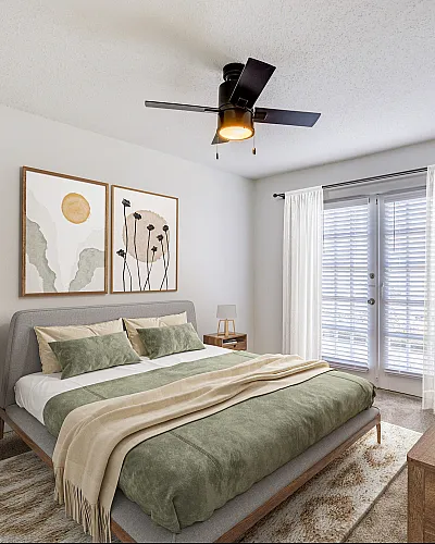 Elegant ReNew on Cantrell bedroom with contemporary decor, featuring a plush bed, stylish hanging plant, and natural light streaming through large windows.