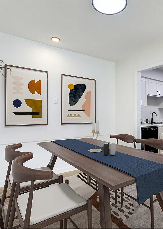 Chic dining room at ReNew on Cantrell with modern furniture, vibrant abstract artwork, and open shelving next to a sleek, well-equipped kitchen.