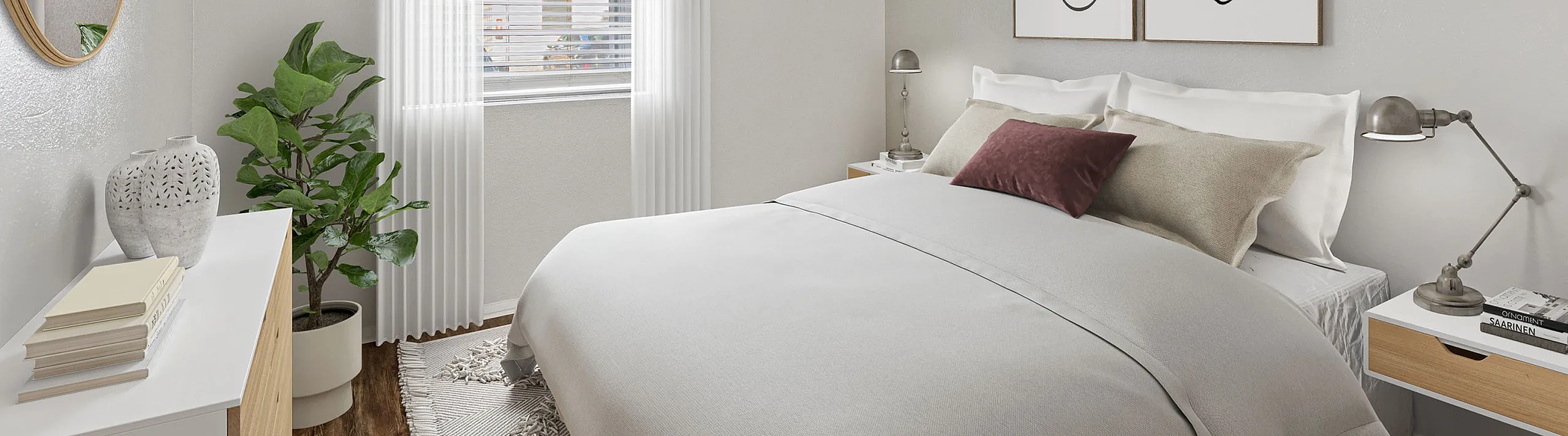 Charming bedroom at ReNew Heights with cozy bedding, elegant wall art, and abundant natural light creating a serene atmosphere.