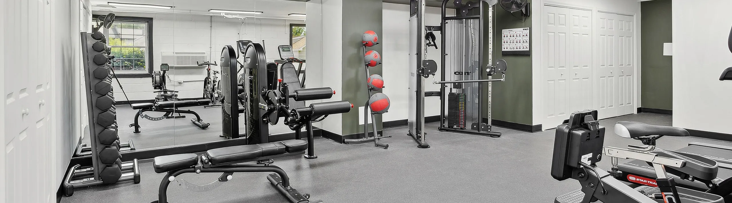 Modern apartment gym at ReNew Parkville featuring state-of-the-art fitness equipment and sleek design, perfect for an active lifestyle.