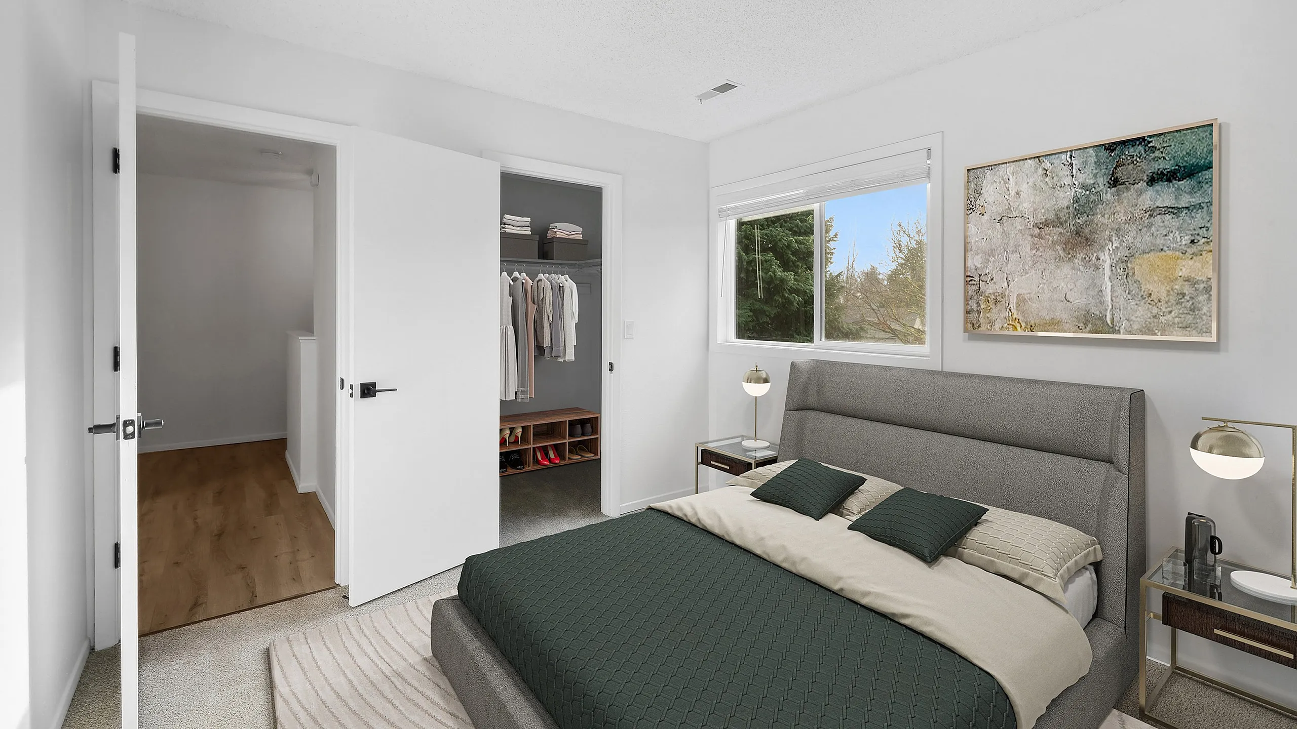 Bright and elegant bedroom at ReNew Rock Creek with a plush bed, modern decor, and a spacious walk-in closet, offering serene views through a large window.