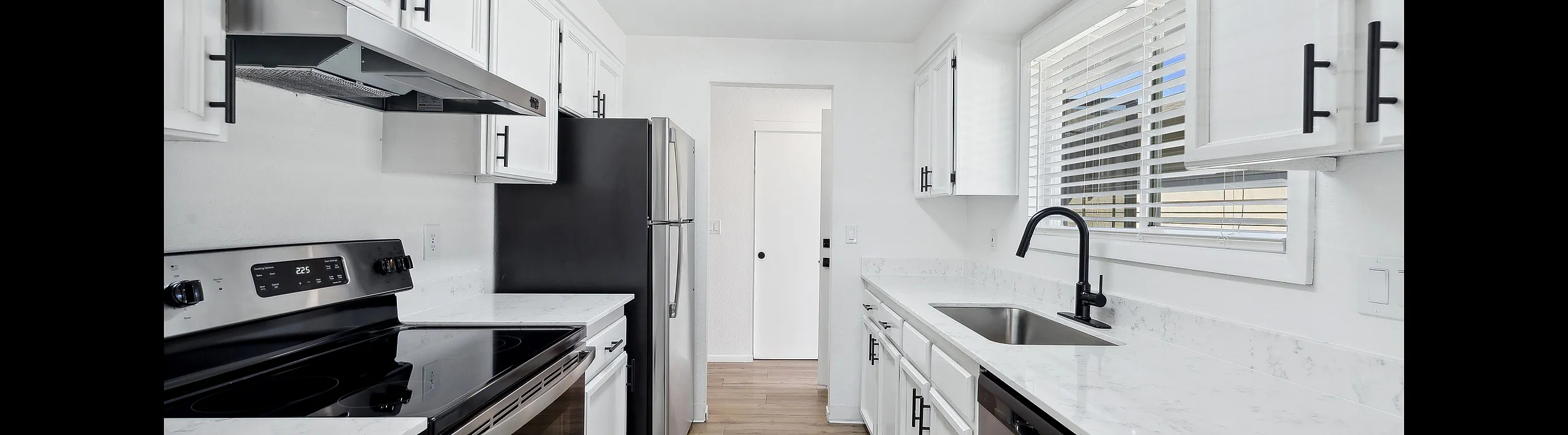 Bright and modern kitchen at ReNew Rock Creek with sleek stainless steel appliances, white cabinetry, and elegant countertops, perfect for culinary creativity.