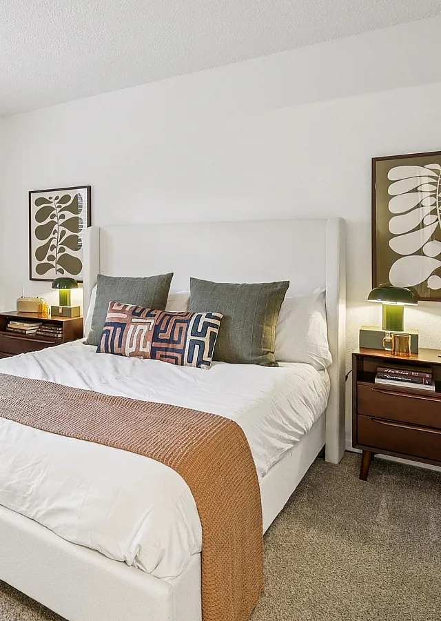 Inviting bedroom with modern decor, featuring a cozy bed, stylish nightstands, large window, and tasteful artwork on the walls.