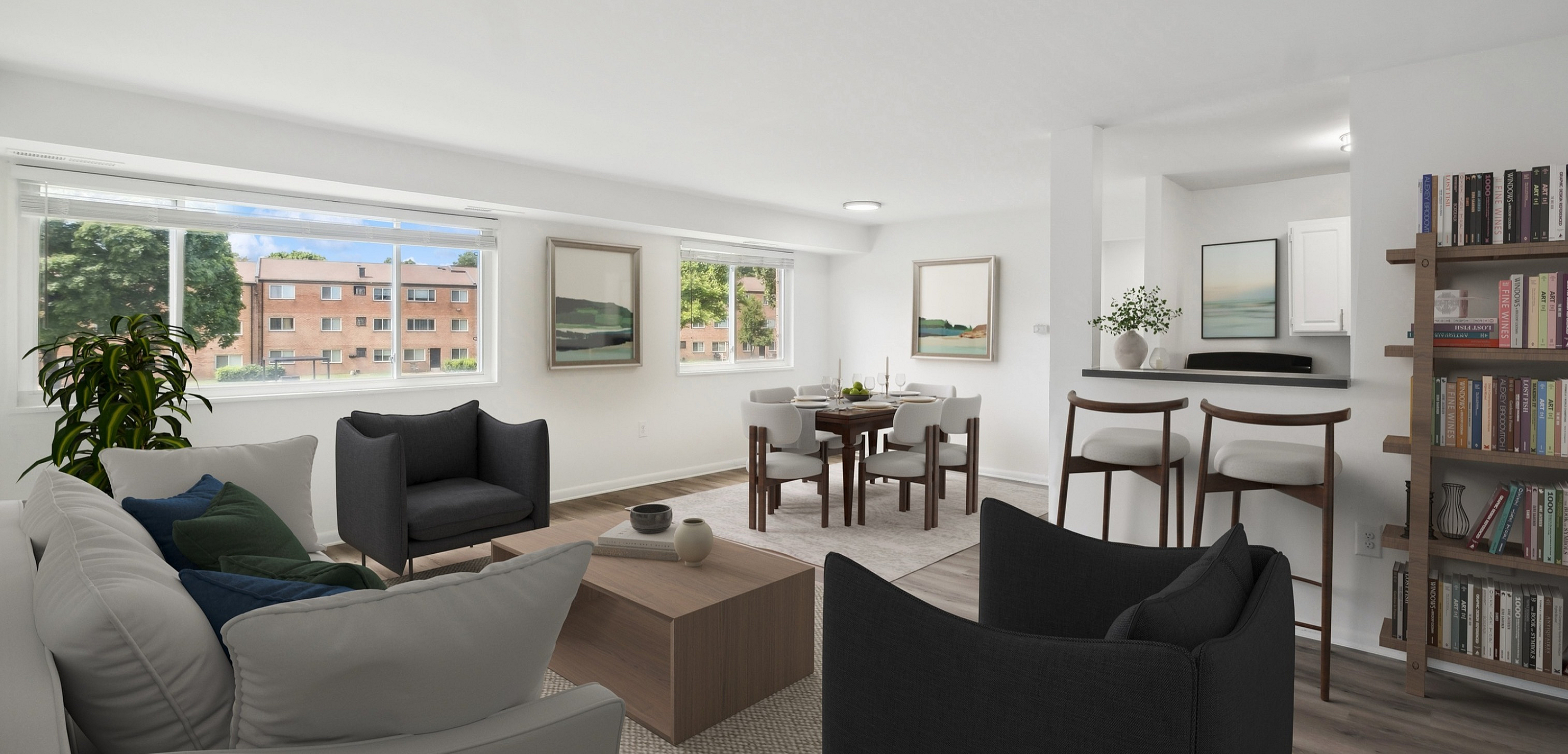 Bright and spacious modern living room with stylish furniture, open dining area, large windows offering natural light and a view of lush greenery.